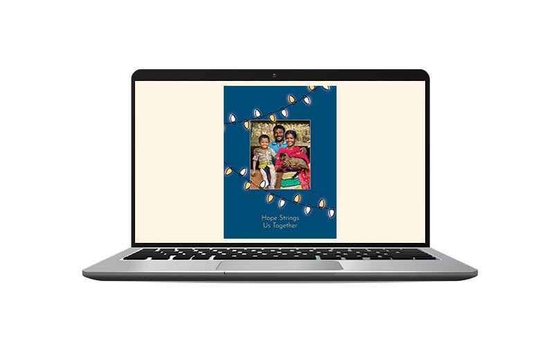 Laptop showing the Honor Card design with a photo of a family of three holding a goat with the message that reads "Hope Strings Us Together"