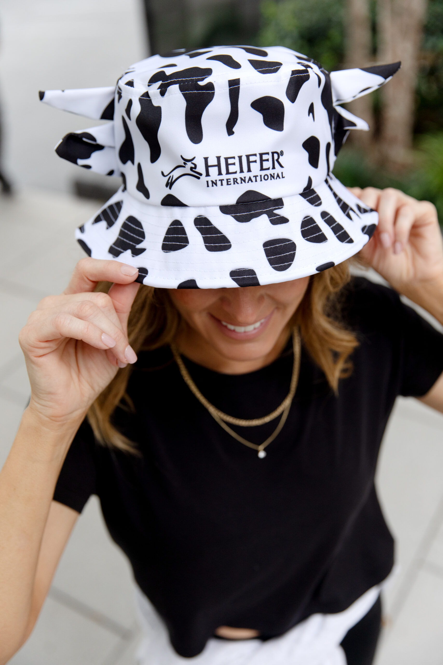 Woman wearing a Cow Print bucket hat
