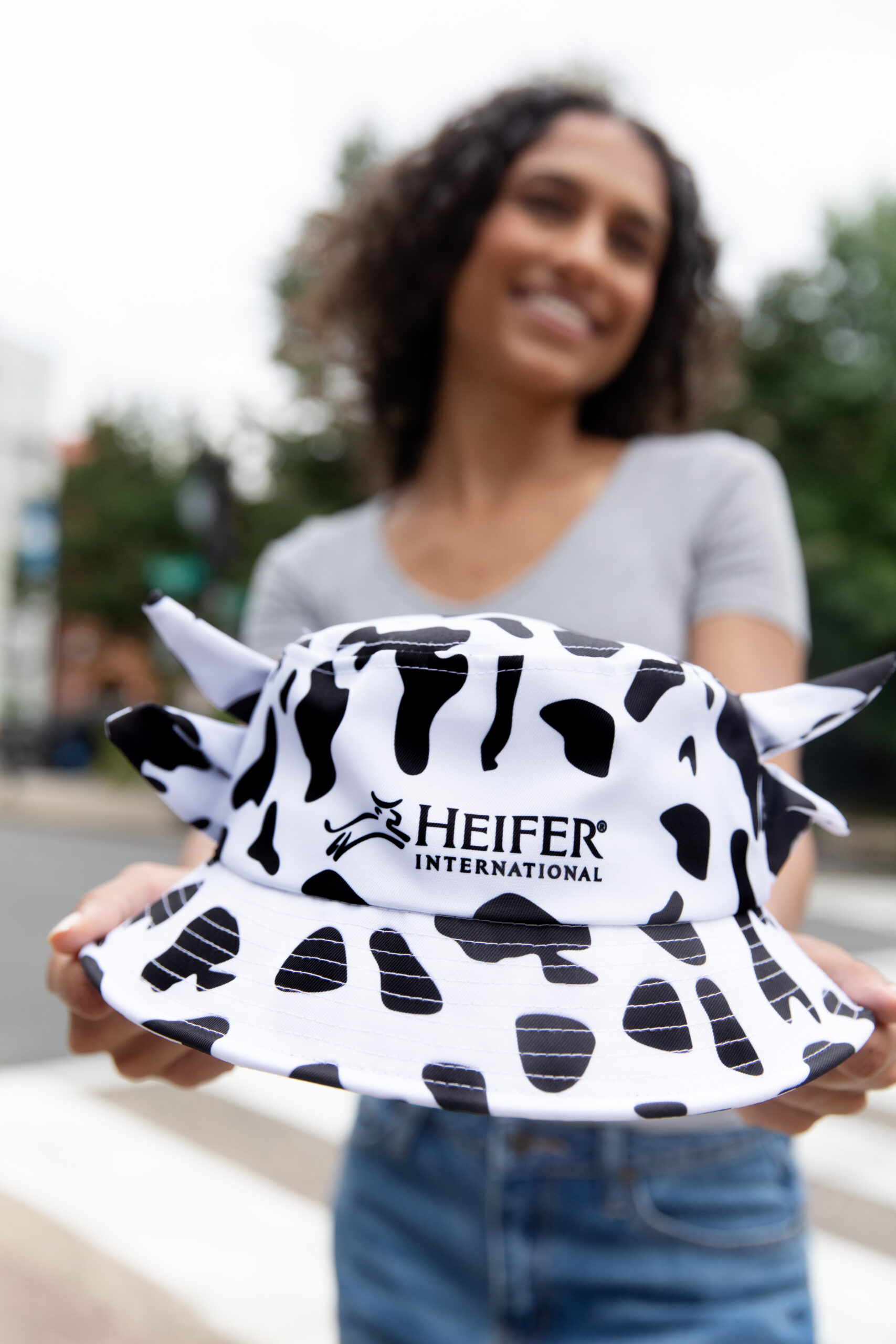 Woman holding a Cow Print bucket hat
