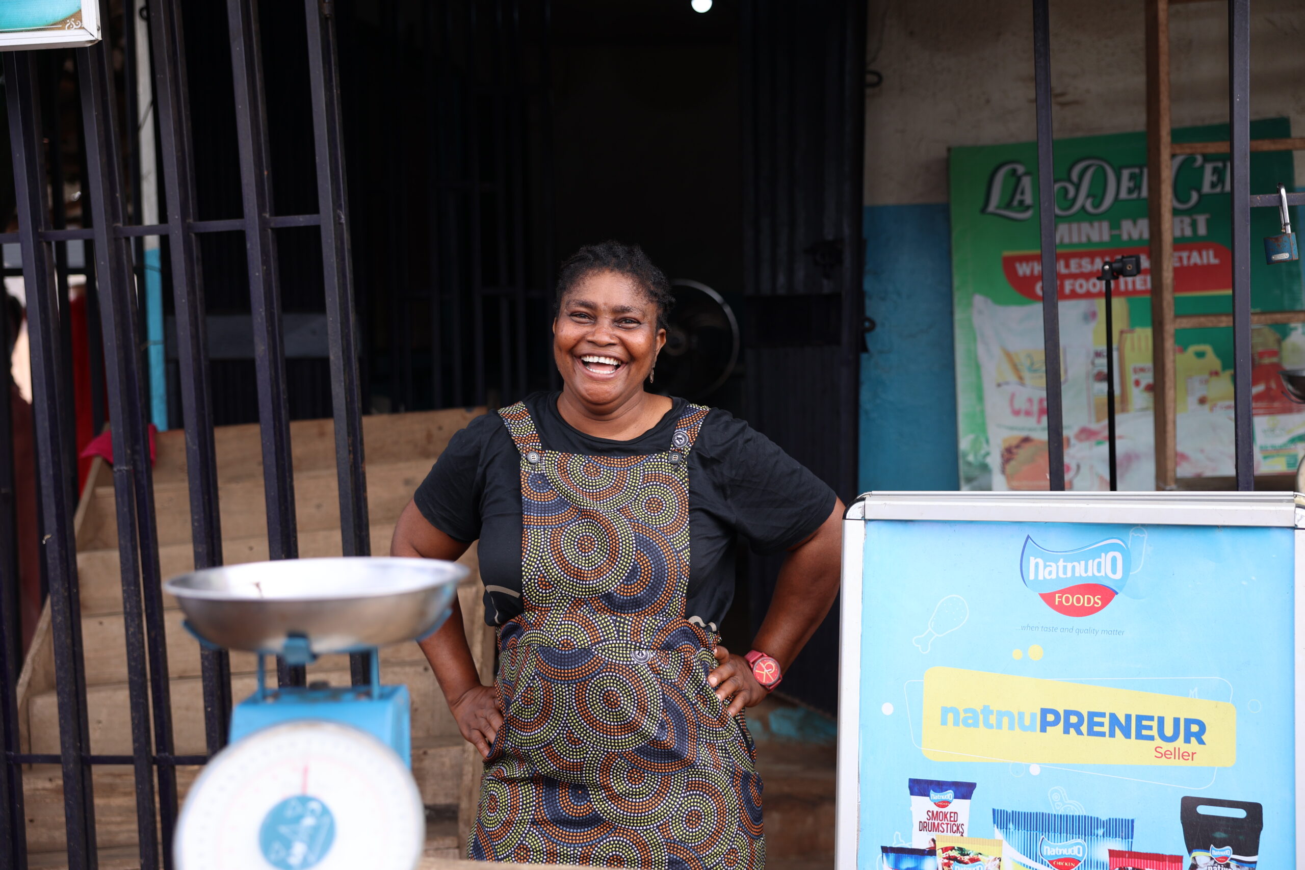 A woman stands outside her poultry shop in Edo State, Nigeria.
