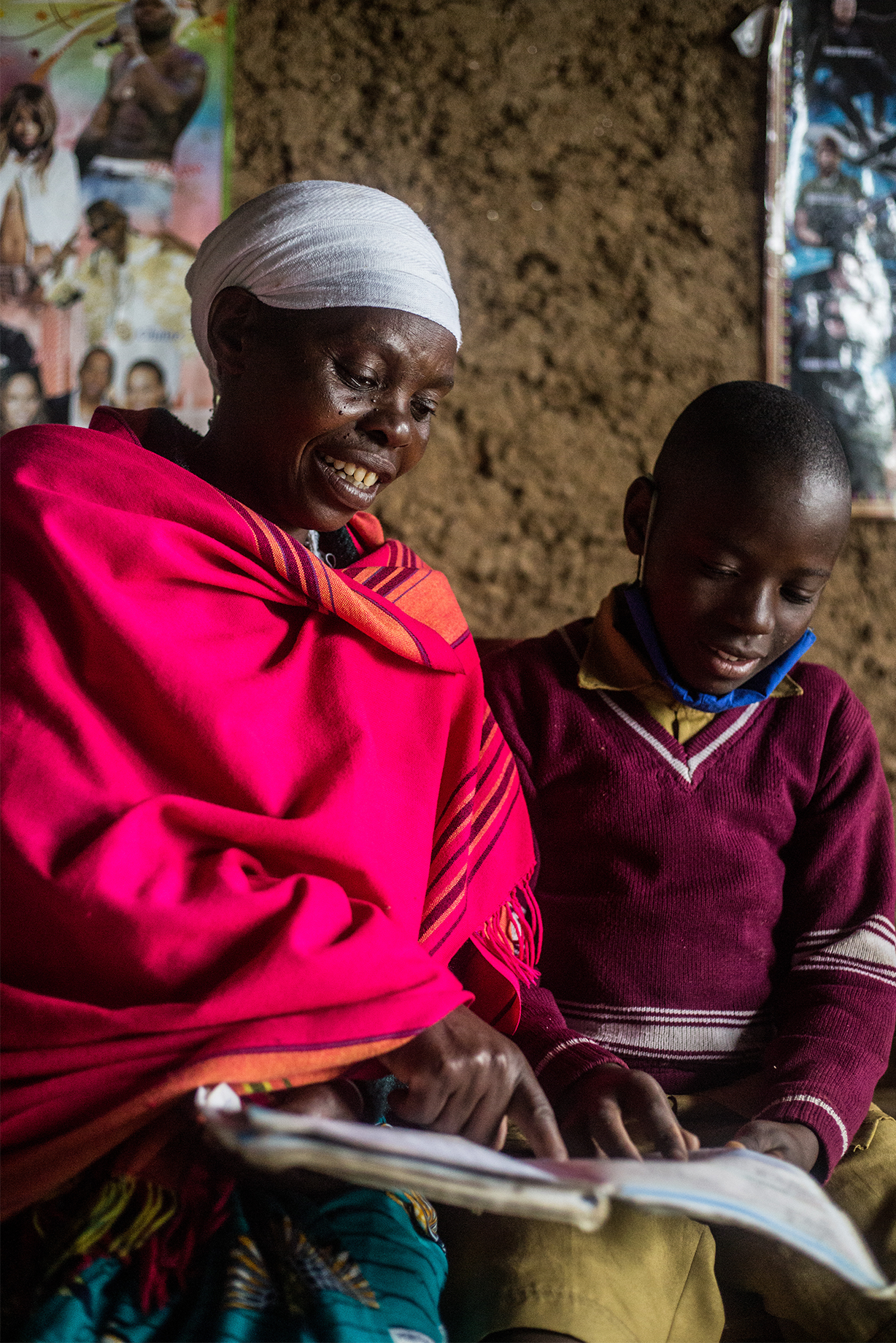 A woman helps her young grandson read.
