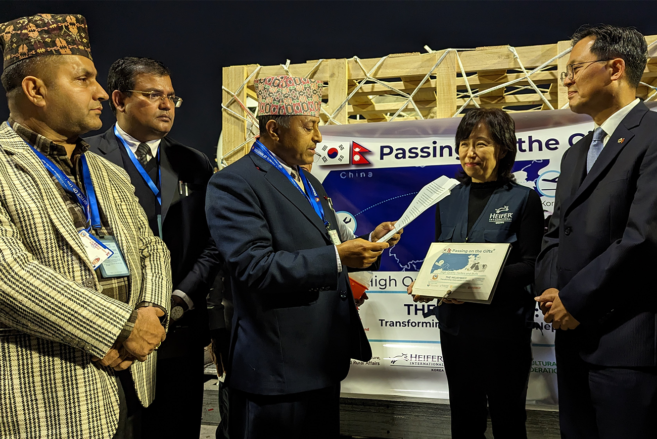 A group of government officials stand together at a ceremony.