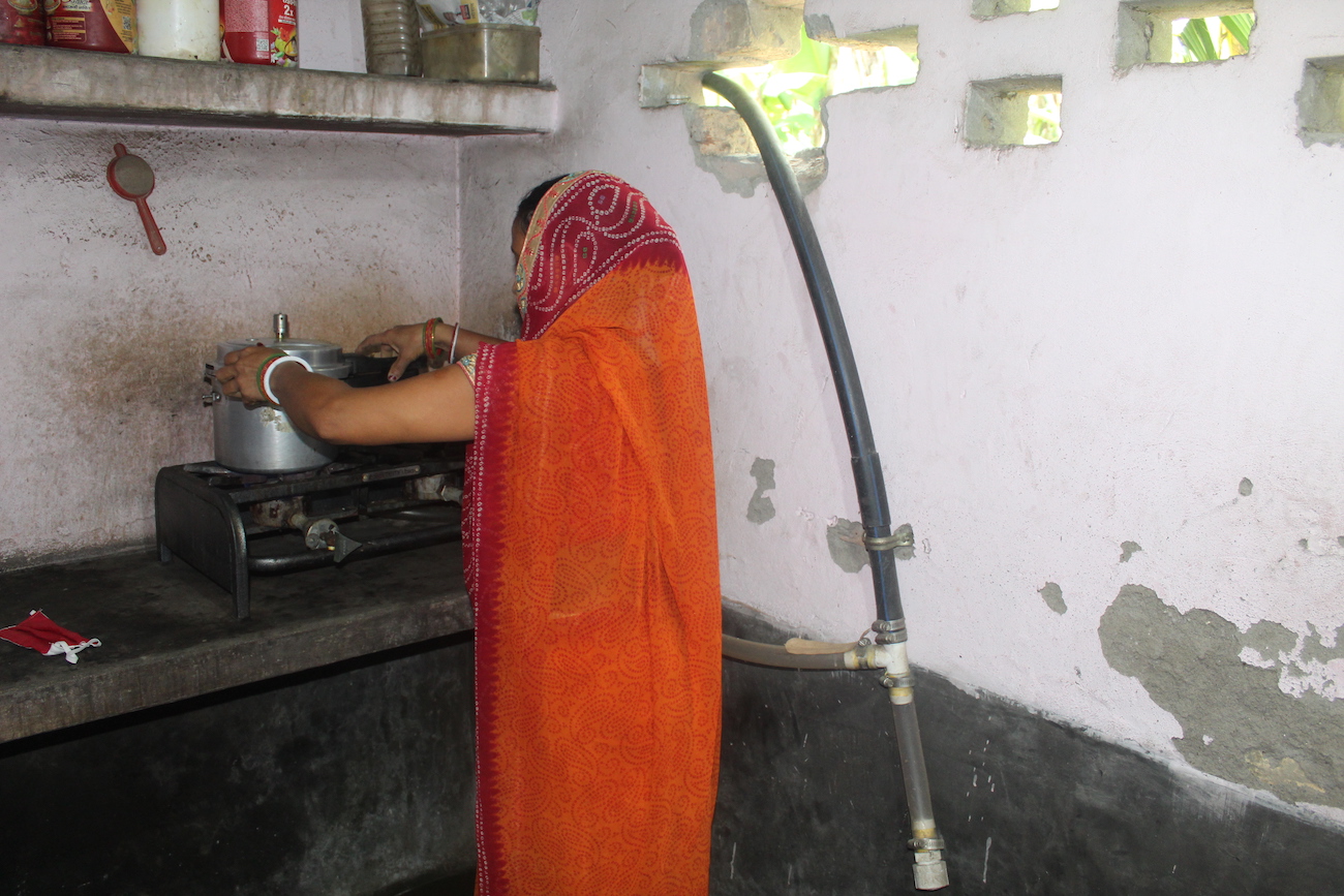 A woman in India cooks at her stove.