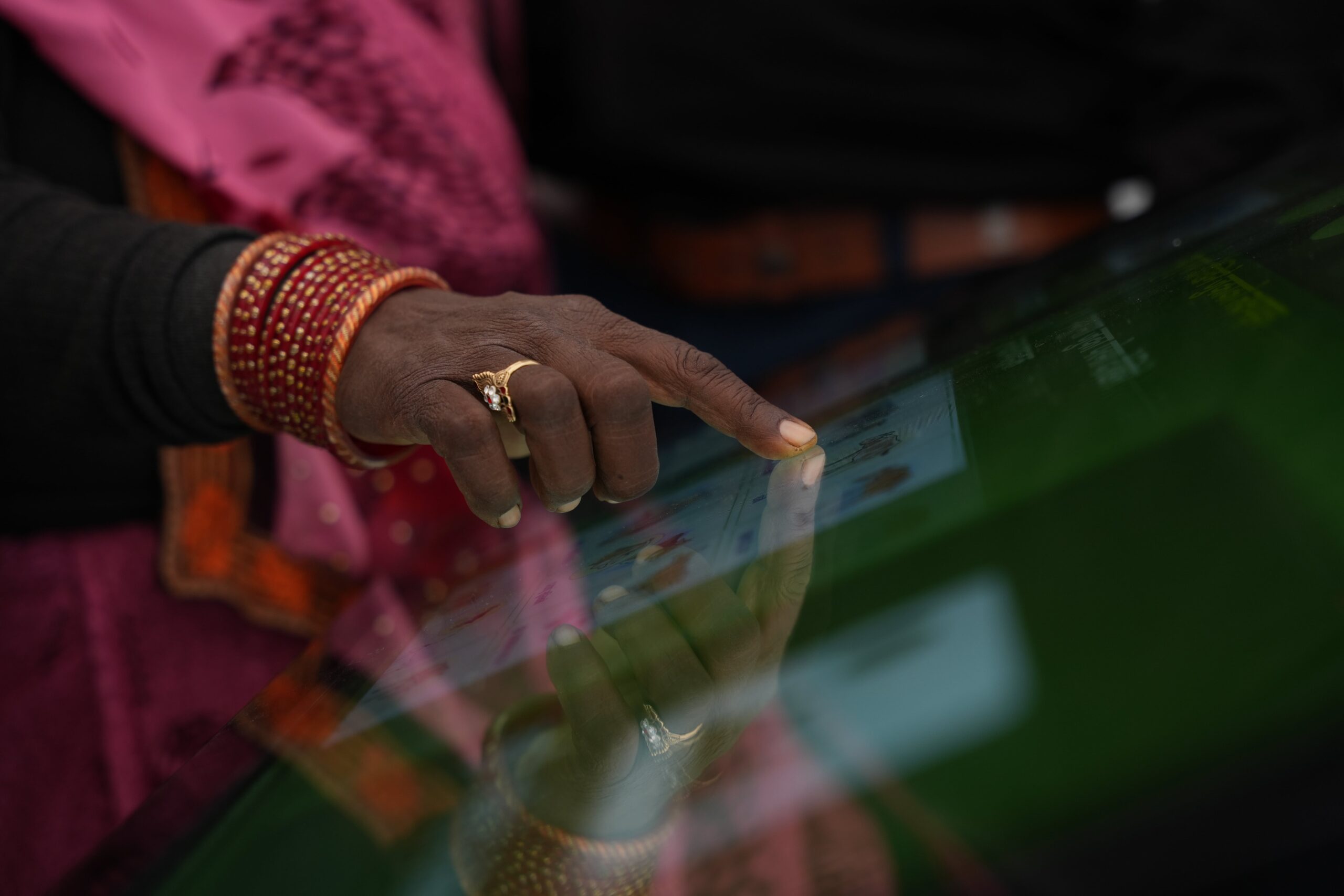 A close up shot of a woman using a touchscreen.