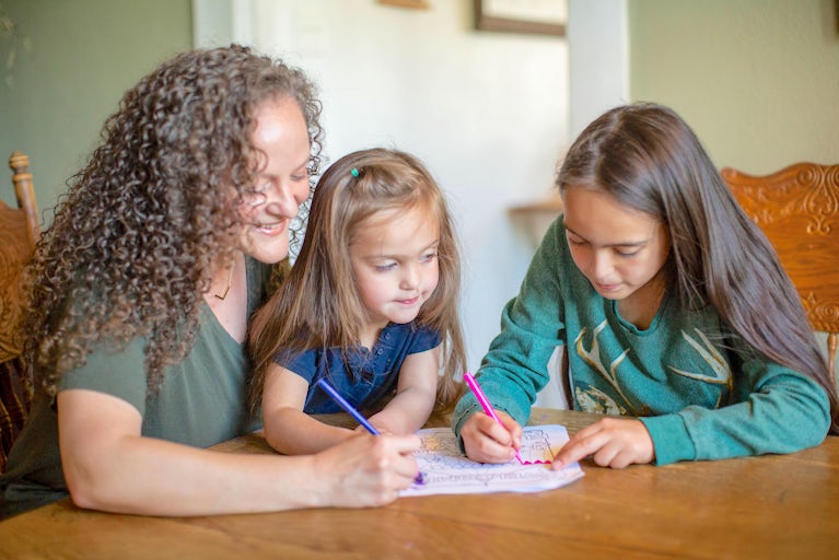 A family writing on paper.