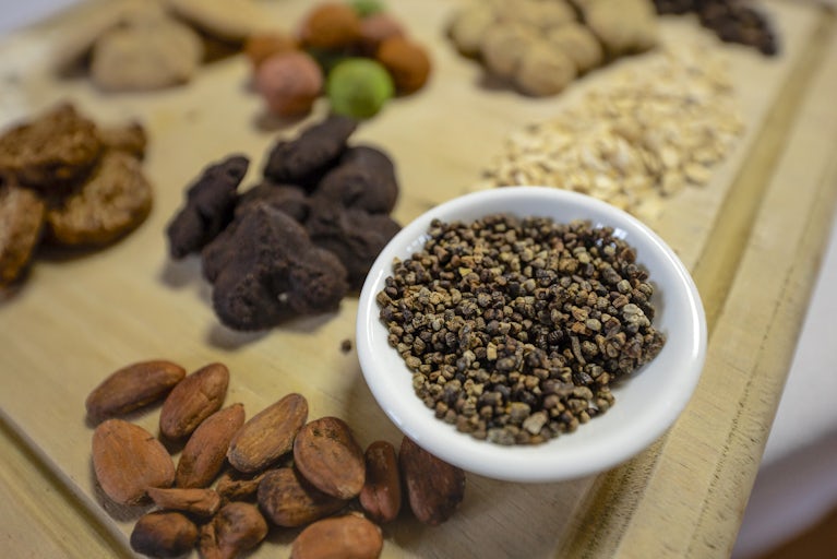 Cardamom (in bowl) and other spices are neatly arranged.