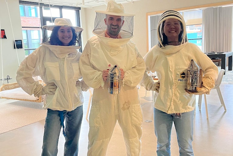 Honey Harvest participants wear beekeeping gear.