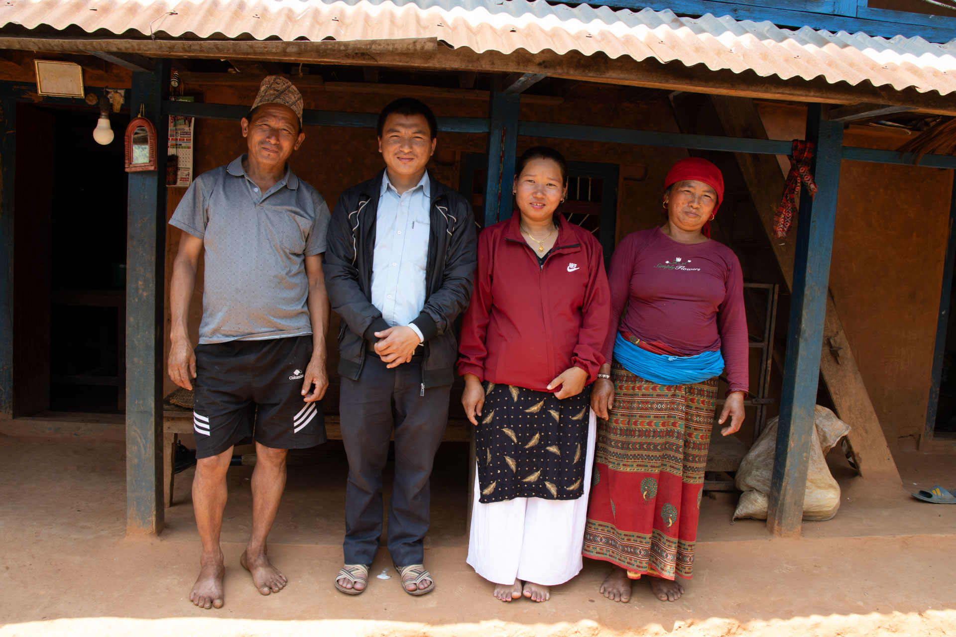 Sushmita and Padam with Padam’s parents outside their home in rural Nepal.