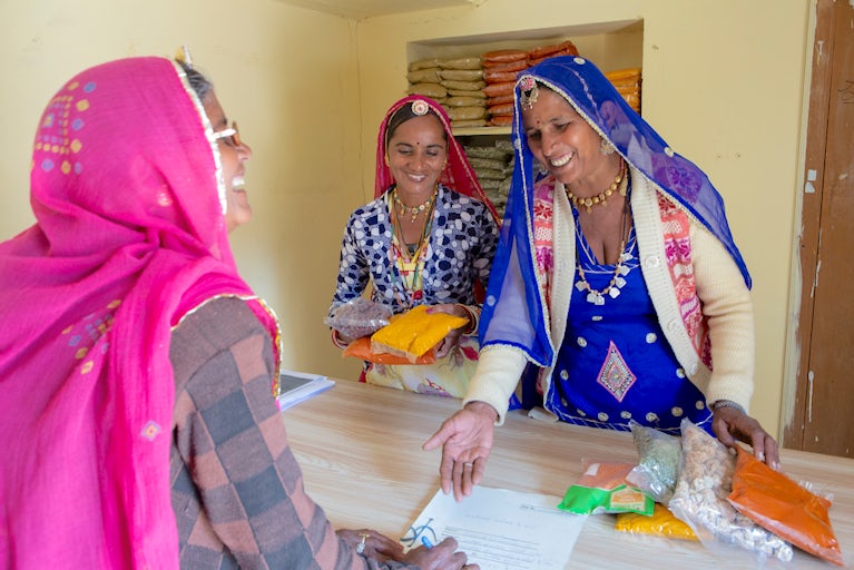 Women in India sell spices.