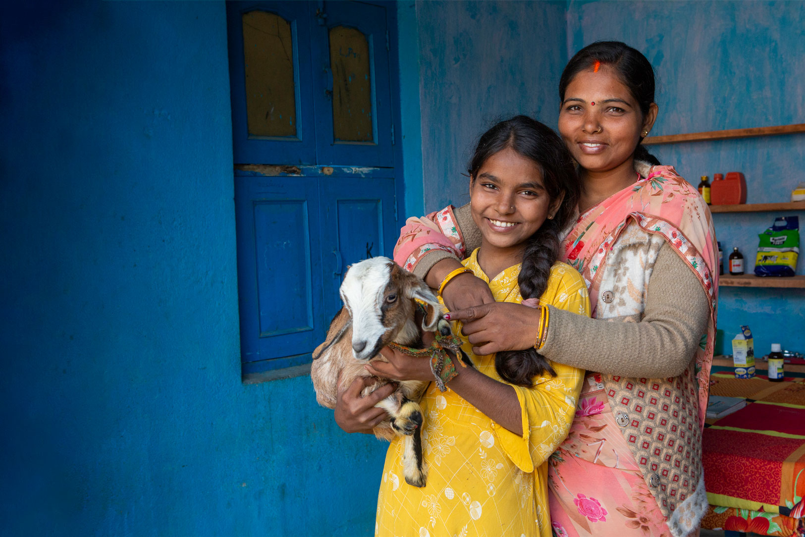 Sandhaya Kumari, 33, and her daughter Khushi Kumari, 12, pose for a picture with one of their goats at their home in Kishunpur Mohni village, India.