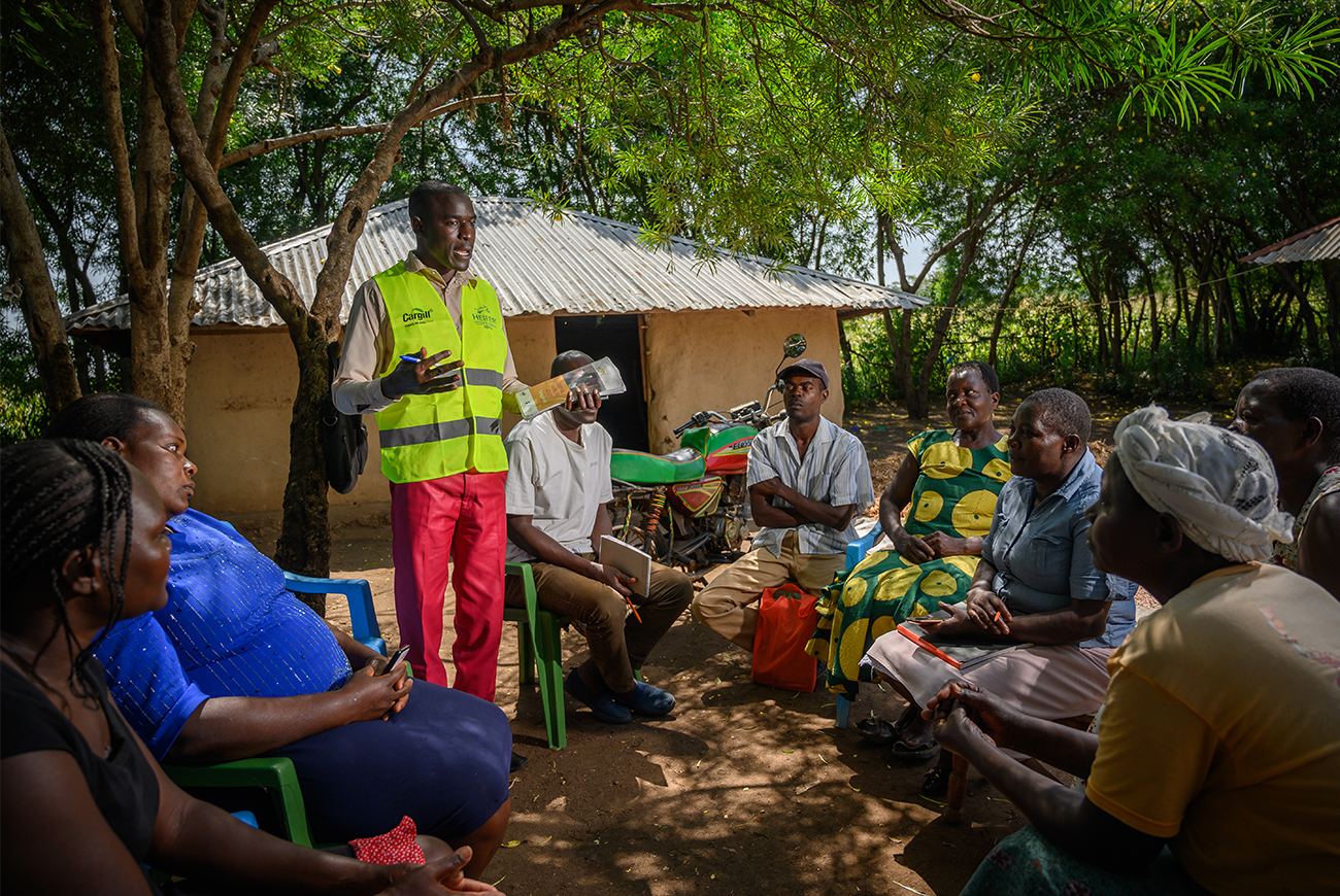 A man conducts a training to a group in Kenya. 