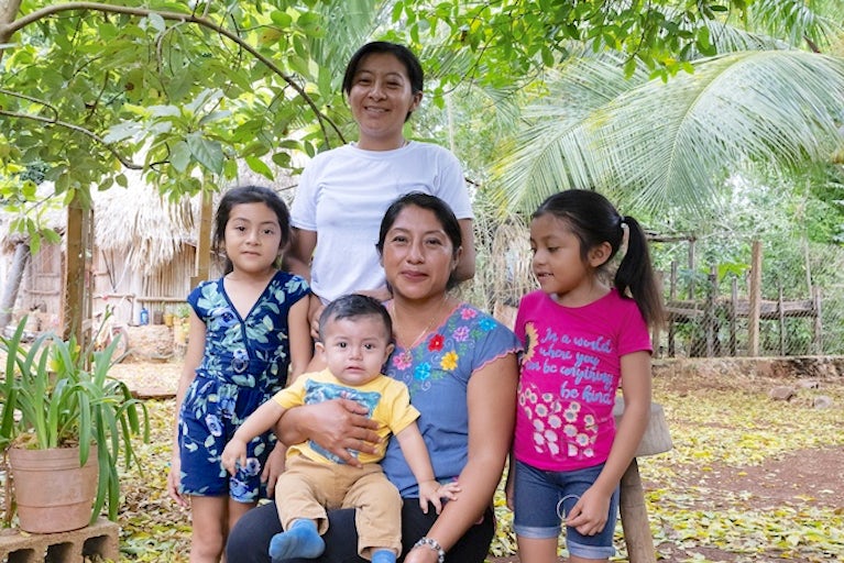 Kancabchén, Quintana Roo, Mexico. Kikibá collective member Lidia Maribel Moo Poot, 37, with her family at their home. In rural settings in Yucatán and Quintana Roo, Mexico, Heifer is promoting the active participation of women in the labor market through the development of family businesses for the production of cage-free and stress-free chicken eggs. Business support and technical training have helped determined women develop income-generating farms and build confidence to overcome challenges and become leaders in their families.
