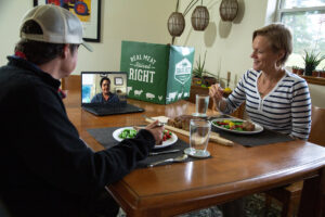 Liz Ellis (right) and Donna Kilpatrick (left) enjoy Mom's Meatloaf during a virtual dinner party with a friend.
