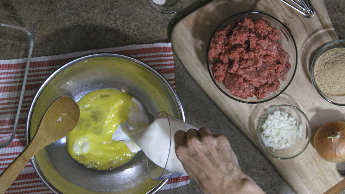 Liz Ellis mixes meatloaf ingredients together. You can see the full process in the video above!