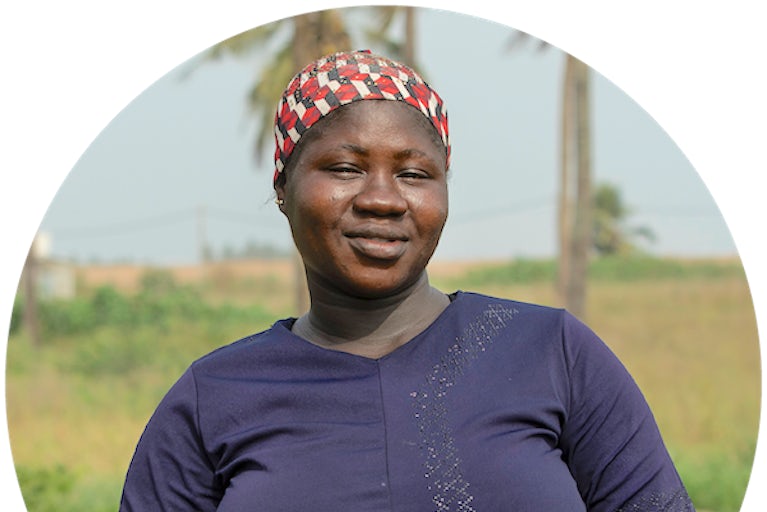 Woman in a headscarf holding a can of tomatoes