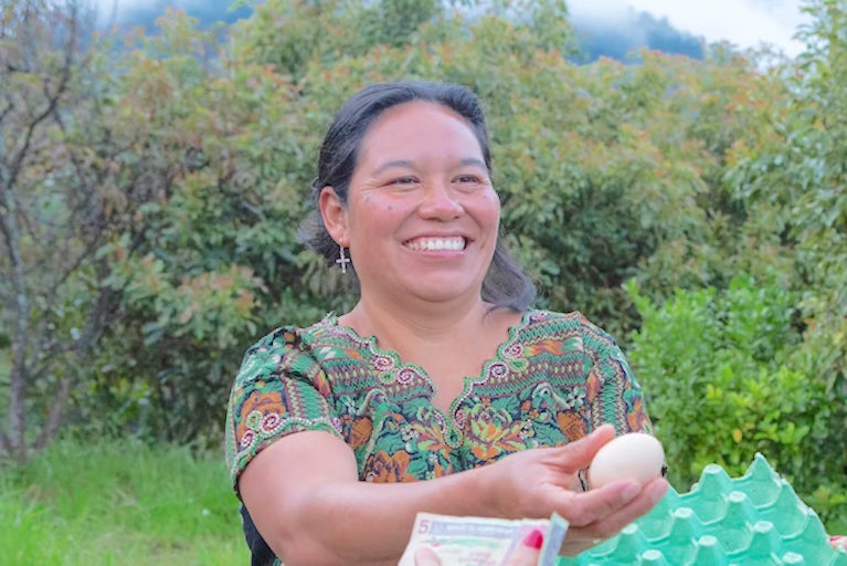 A woman gifting an egg to another woman