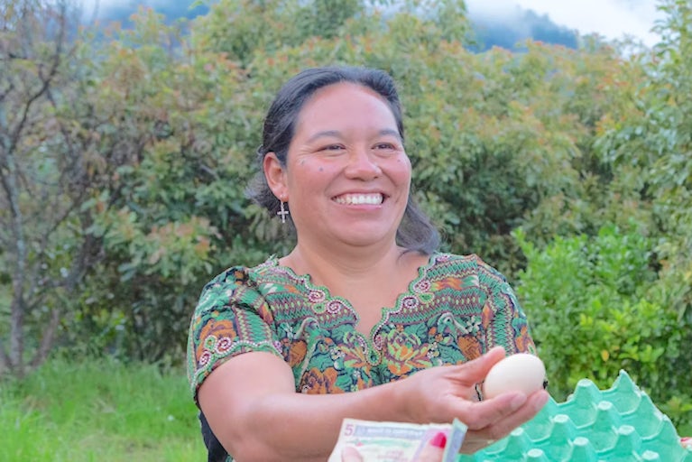 A woman gifting an egg to another woman