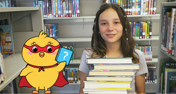 Girl with stack of books next to Hatch the chick.