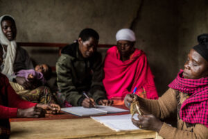 Members of a Heifer-supported savings and loan group in Rwanda gather for a weekly meeting to contribute savings and conduct bookkeeping. Photo by Jacques Nkinzingabo/Heifer International.