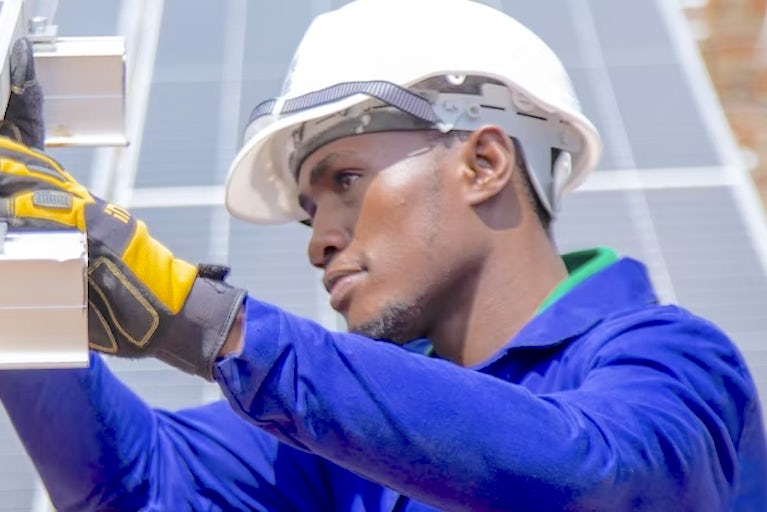 An engineer installing a solar panel