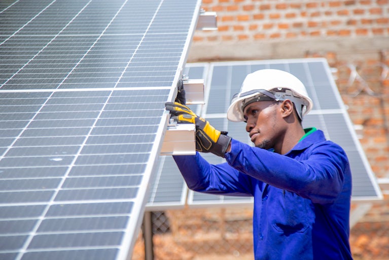 An engineer installing a solar panel