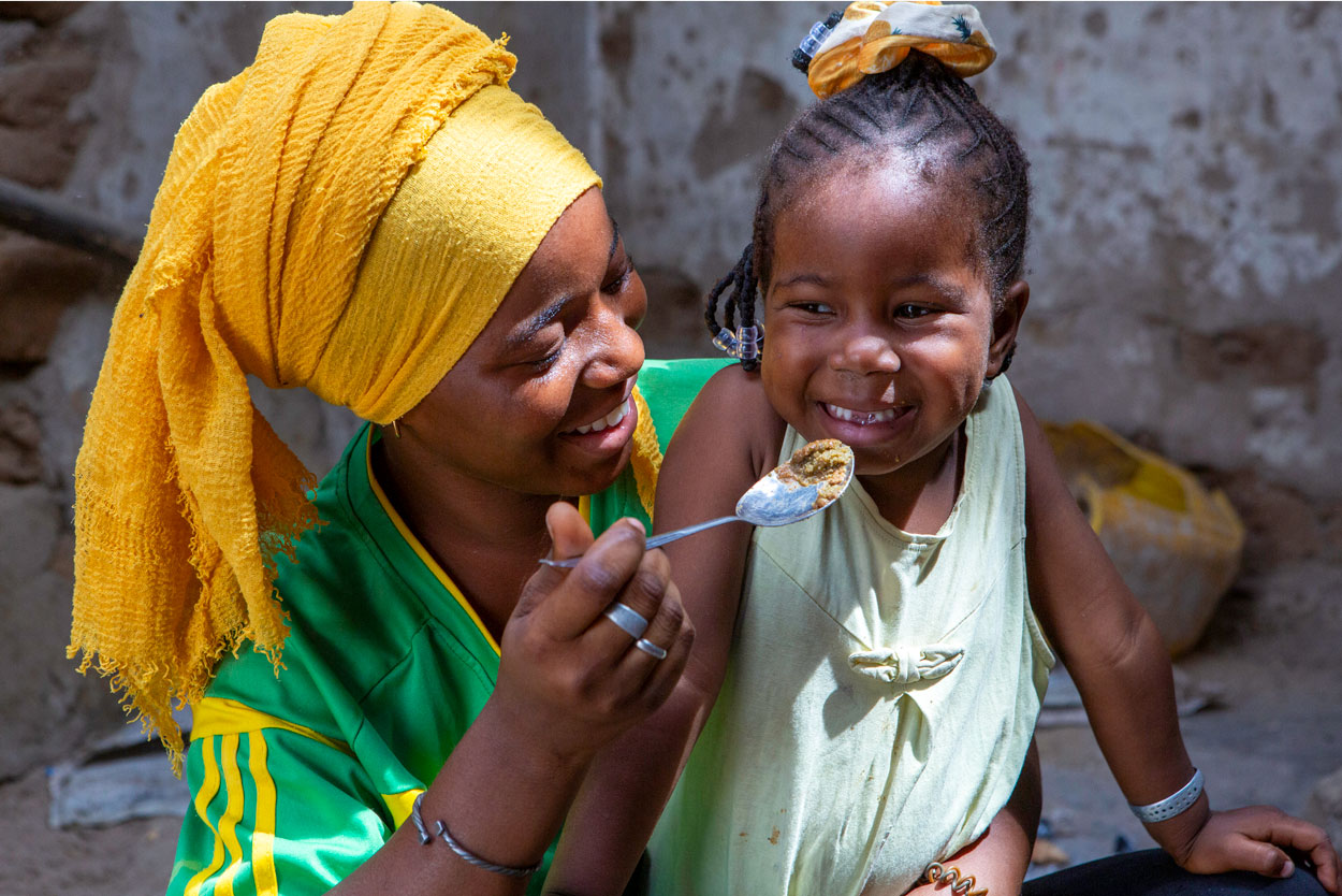Awa Sankhare, 15, feeds Yacine Sylla, 3, in their kitchen in Thiomby Bambara village, Senegal.