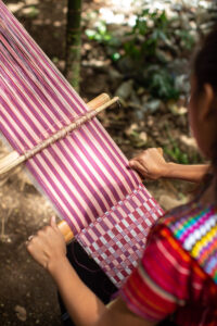 Rosa's daughter, Tania, weaves a shawl colored with different shades of cochineal.