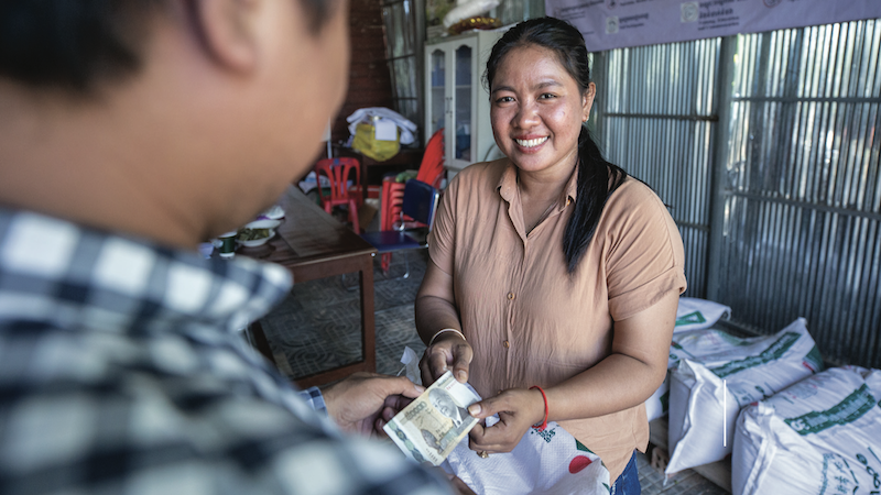 A farmer completes a transaction.