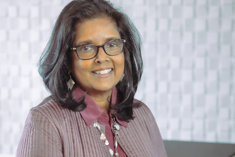 Surita Sandosham, president and CEO of Heifer International, stands with her hands clasped.