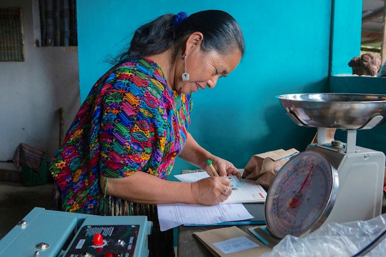 Women at working station filling out paperwork
