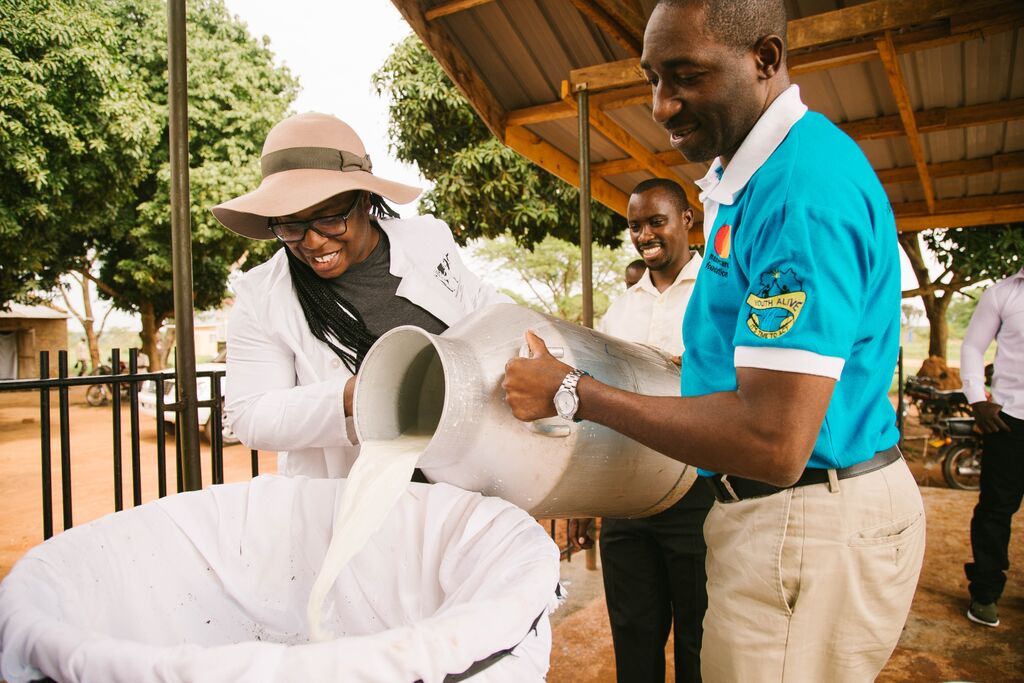 Uzo Aduba experiences Heifer's impact first-hand on a trip to Uganda in 2016 where she helped process milk at a community-owned dairy center. Uzo Aduba