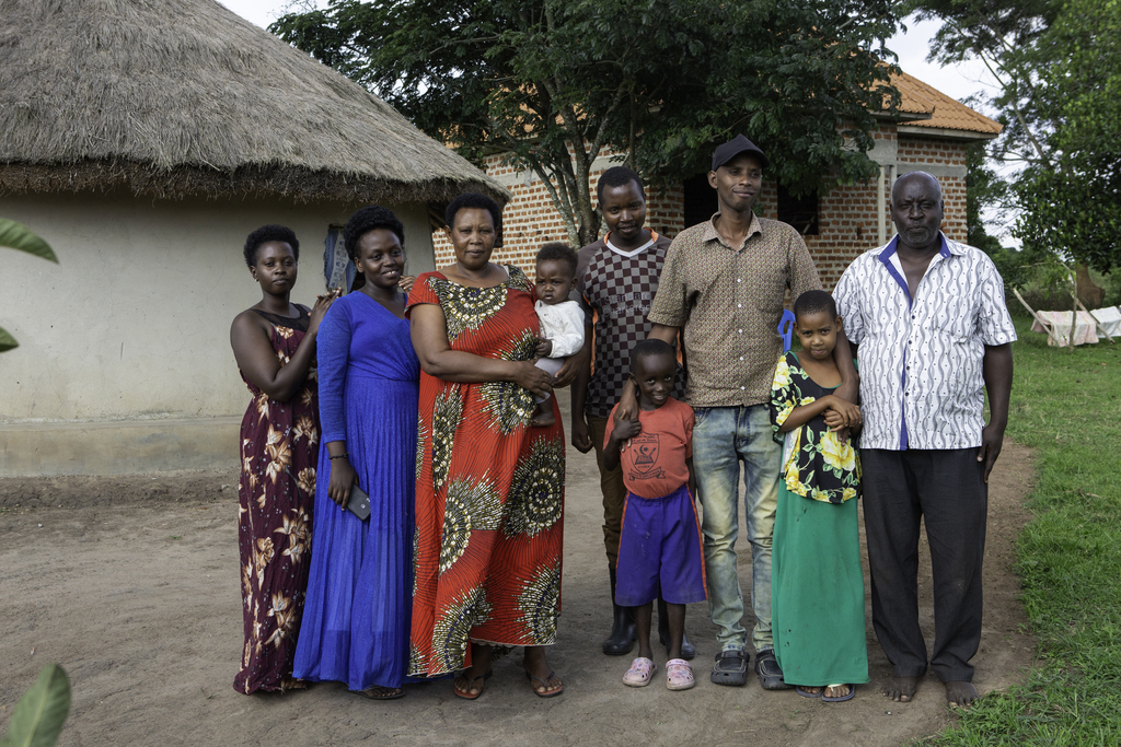 Margret stands with her family in Uganda.