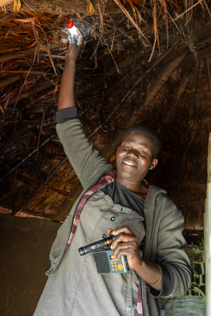 Susan adjusts a solar-powered light inside the cowshed.