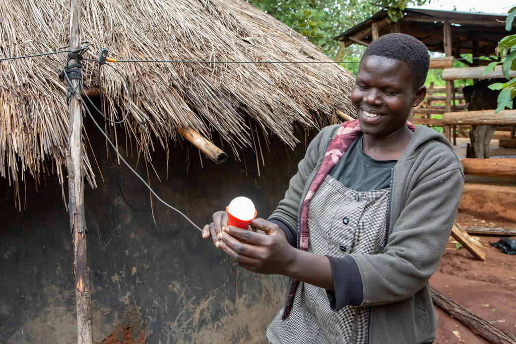 Susan shows a solar-powered light outside her cowshed.