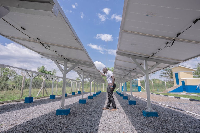 A man inspects solar panels.