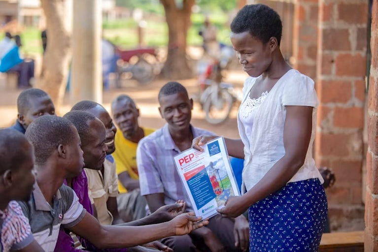 A woman in Uganda presents to a group of farmers.