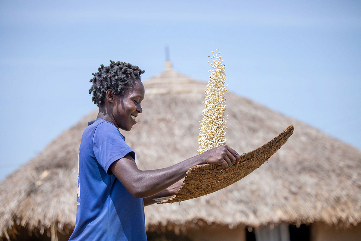 A woman in Uganda holding seeds.