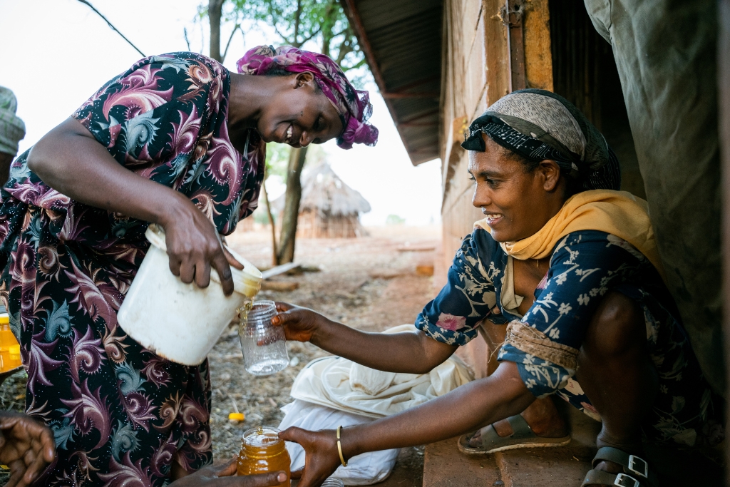 Workeye Endris (29) and Bezuye Yalew (30) preparing honey for sale at the honey storage and shop of their Common Interest Group (CIG) in Asosa, Abrahamo woreda.