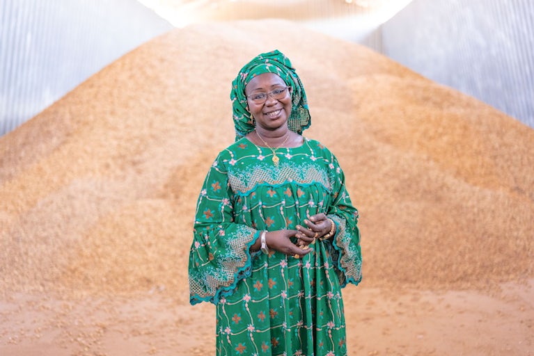 Woman stands in front of seeds.