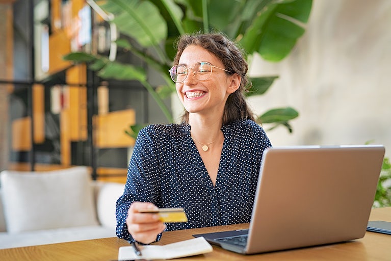 a woman makes an online purchase using a credit card.