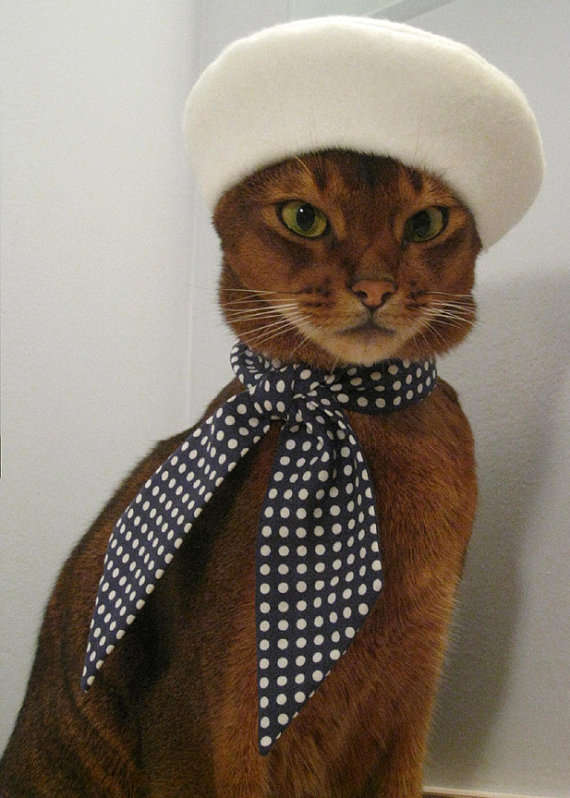 Life is a cat beret for the Etsy shopkeeper Cat Atelier, who designs high feline fashion. A tabby cat wears a white baret and black polka dotted ascot.