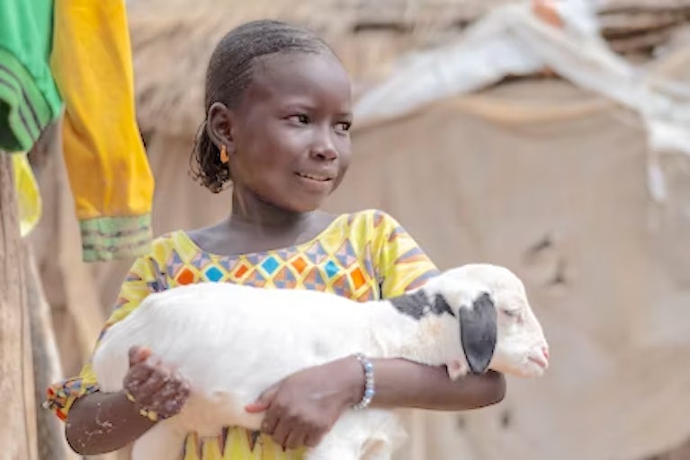 Young girl holding a goat