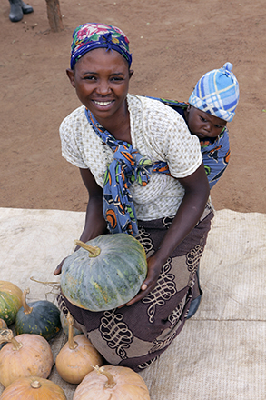 If looks could kill. A baby giving serious side-eye to a gourd.