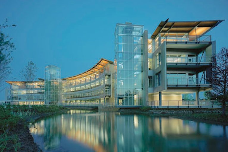 Heifer headquarters at night with a reflective pond