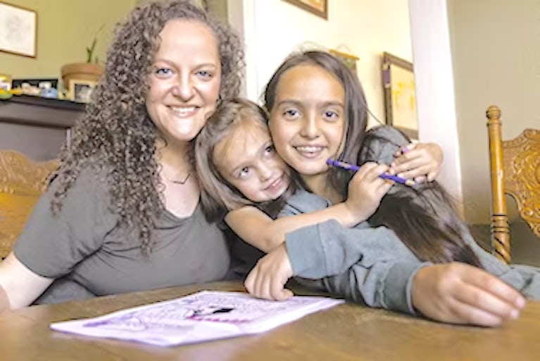 A family of women sitting at a table.