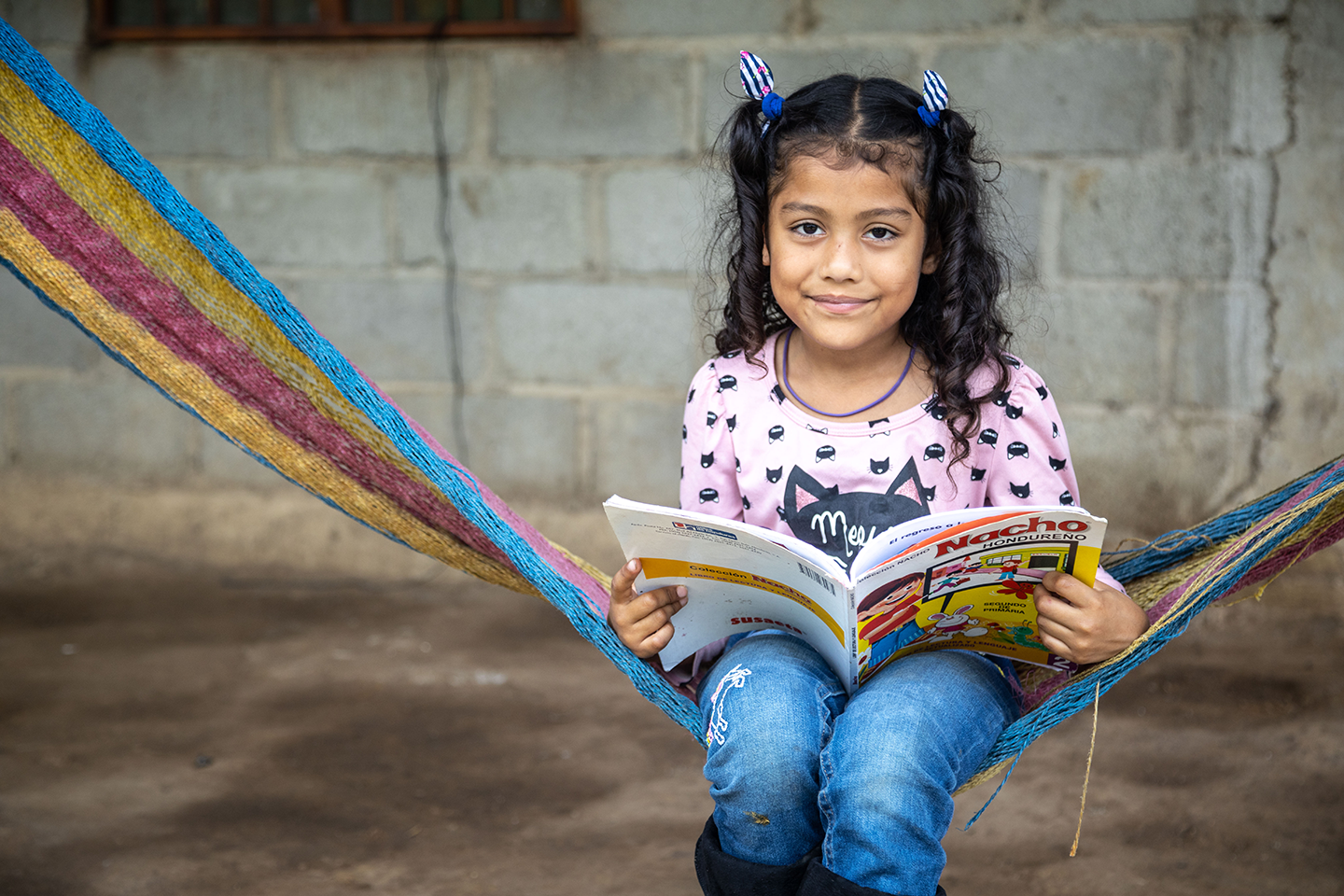 Smiling girl reading.