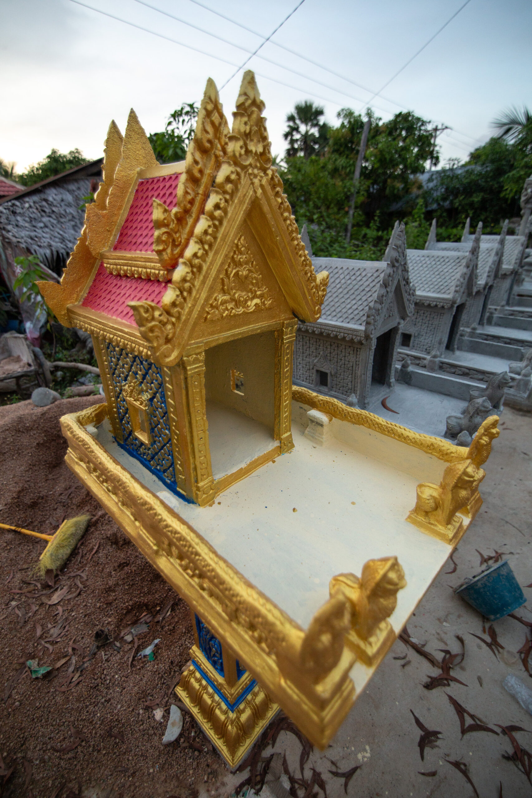 A new spirit house is for sale at a roadside shop.