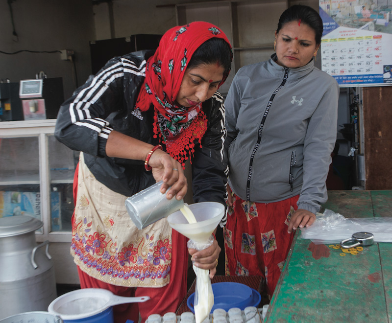 Women preparing milk bottles.