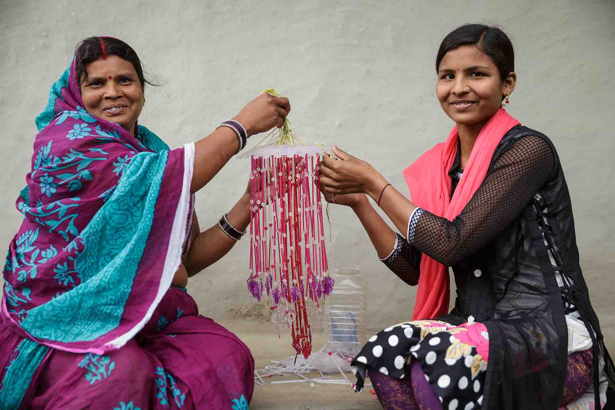 Munni Devi and her daughter Preeti Kumar, 19, make a wind chime together. Munni Devi and her daughter Preeti Kumar, 19, make a wind chime together.