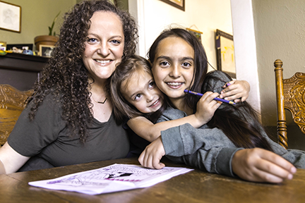 Woman and children smiling.